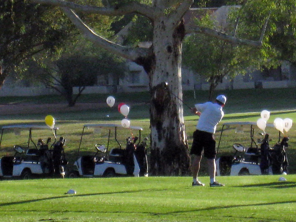 Executives teeing off at a golf tournament