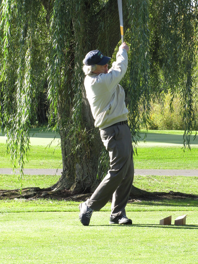 Golfer completing swing follow through